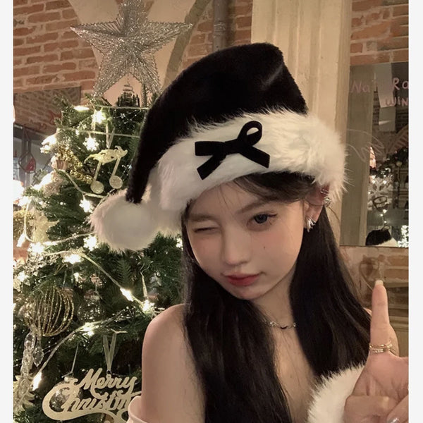 Ladies Christmas Bow Hathat headwear for bank robbers crossword featuring a black tall crown Santa hat with white faux fur trim and a red outfit.