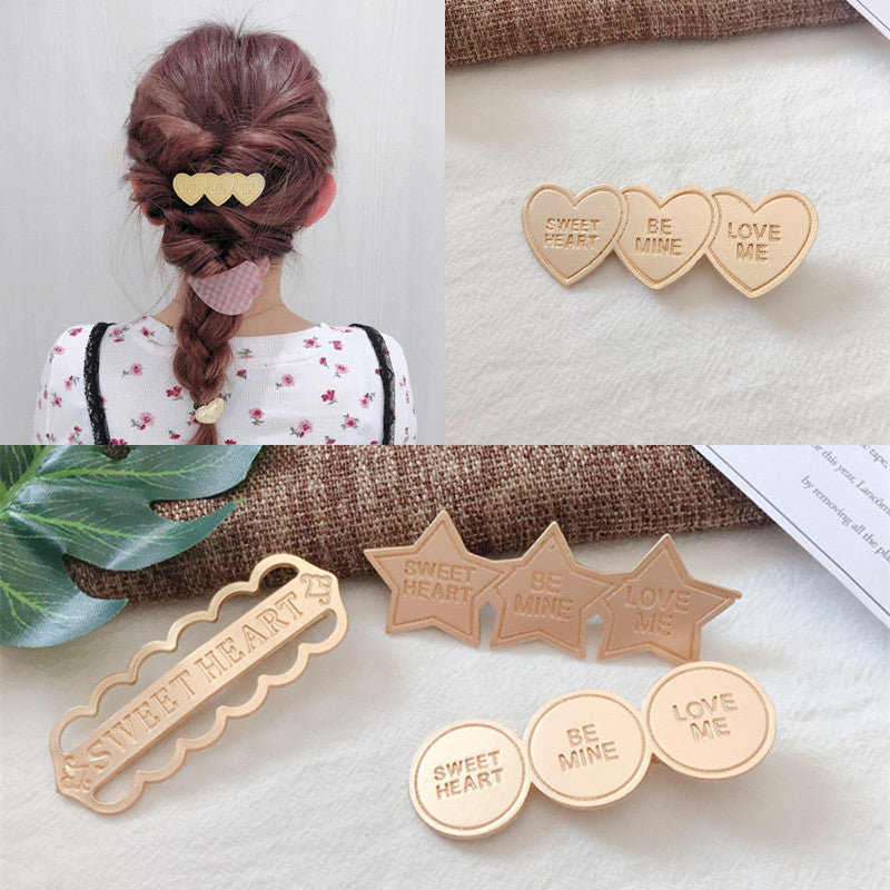 Gold alloy letter clip hair accessories with engraved messages like 'BE MINE' and 'LOVE ME', ideal for weddings and travel gifts in Europe.