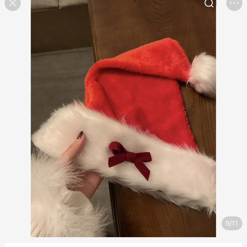 Ladies Christmas Bow Hathat headwear for bank robbers crossword featuring a black tall crown Santa hat with white faux fur trim and a red outfit.